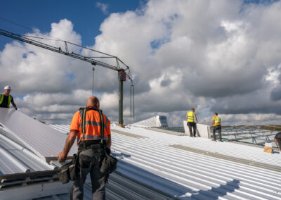 Fitting roofing panels on warehouse